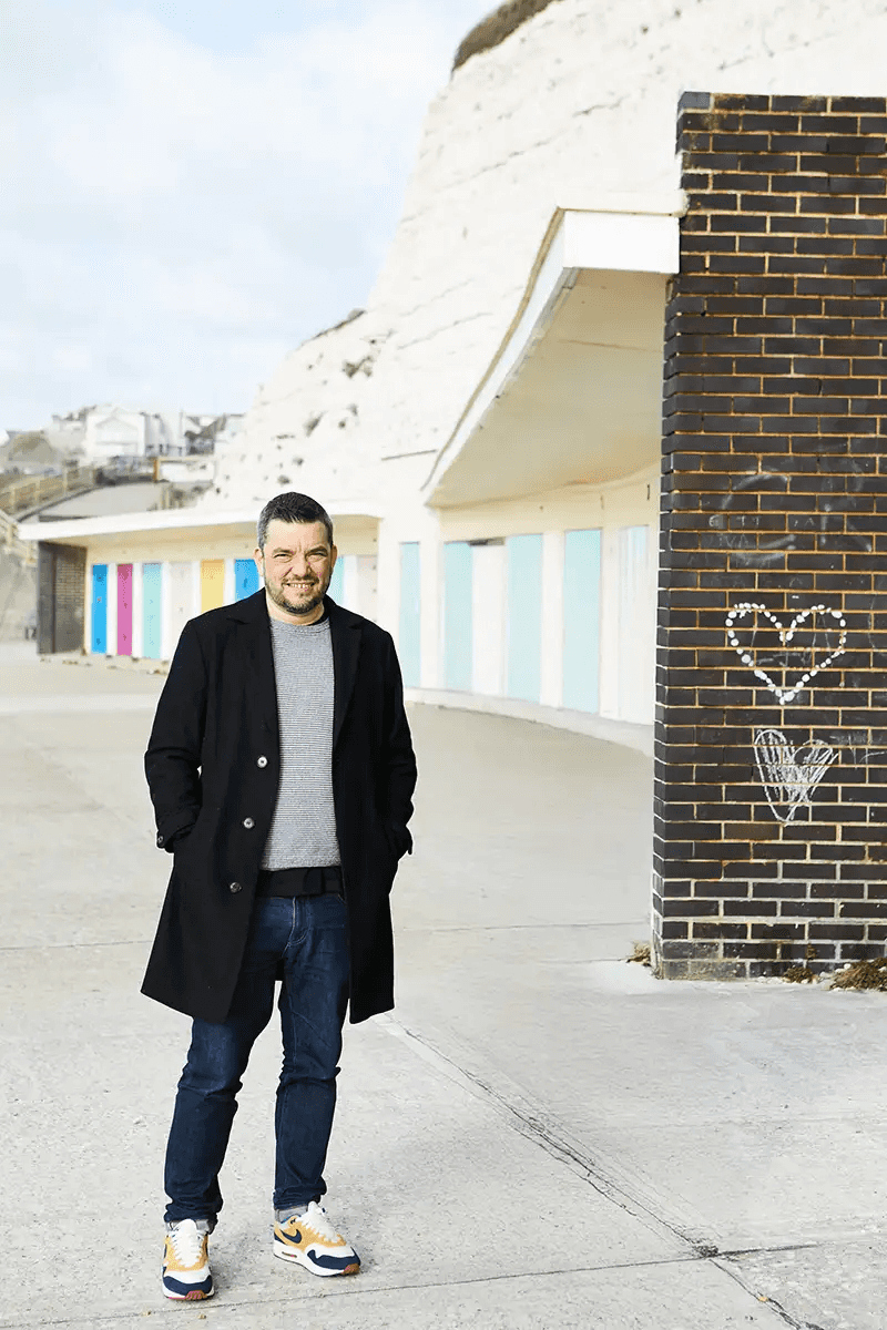 Tom, web designer in Saltdean, by the beach huts on the undercliff walk